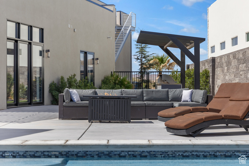 View of swimming pool with an outdoor living space and a patio