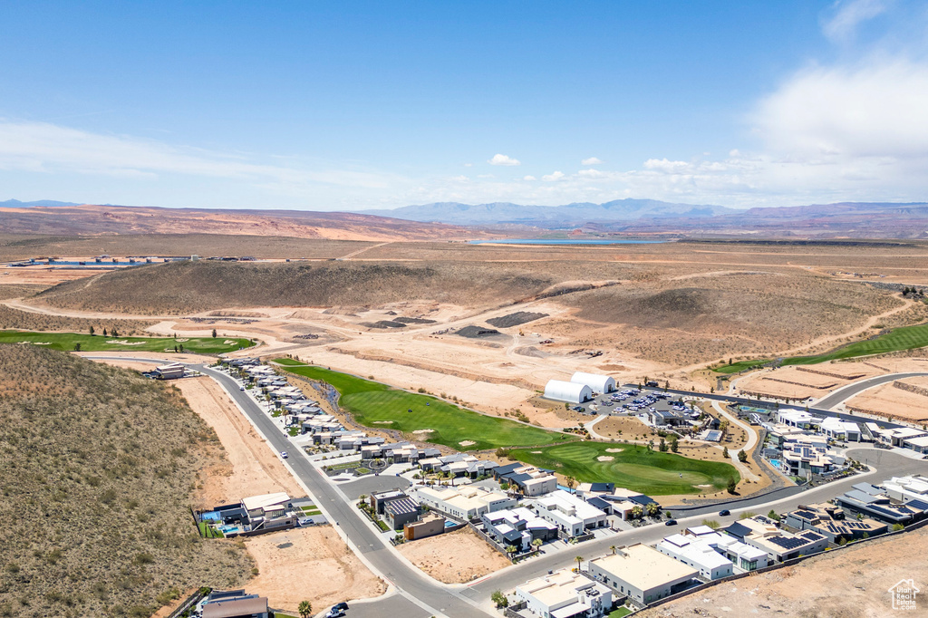 Aerial overview of property's location featuring a mountainous background and a desert landscape