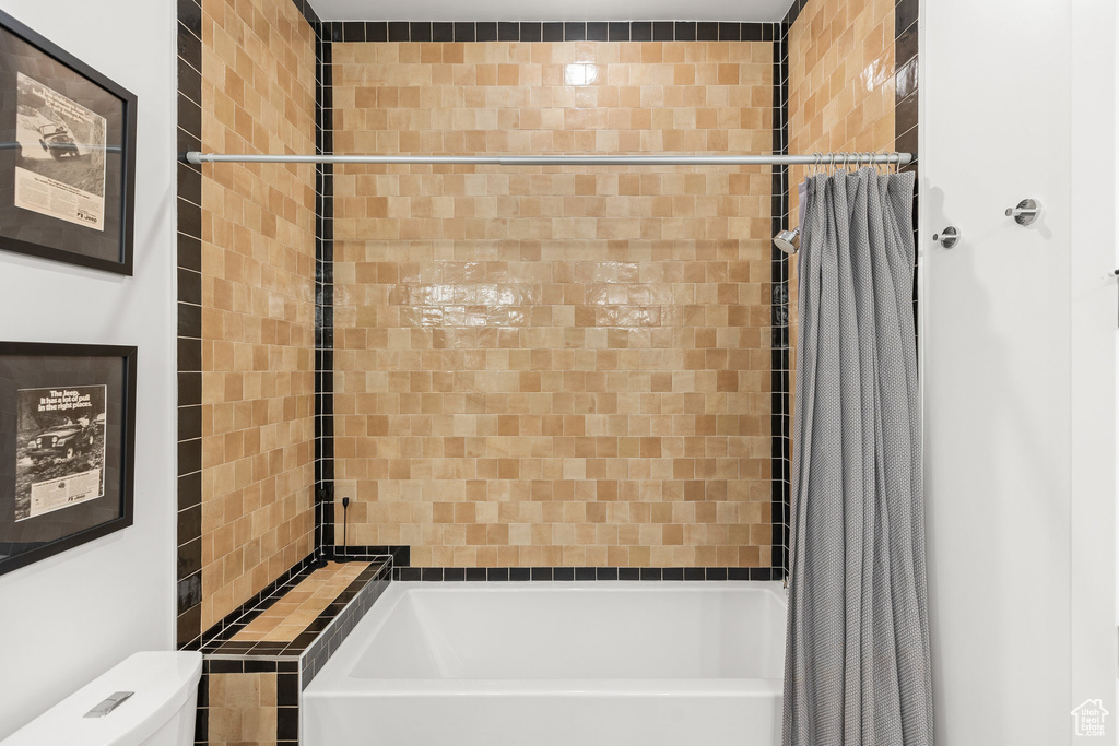 Full bathroom with shower / bath combination with curtain and toilet