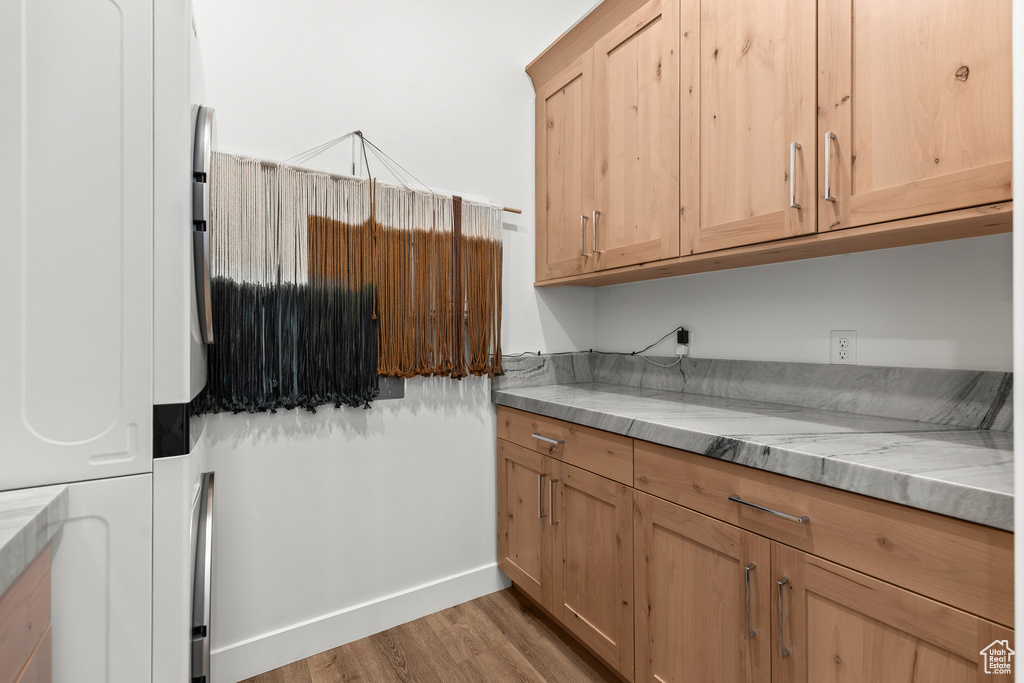 Washroom with light wood-style flooring and baseboards