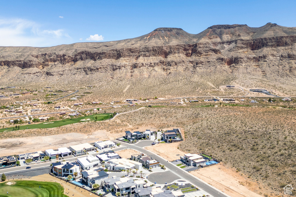 Aerial view of property's location with mountains, nearby suburban area, a golf course, and a desert landscape