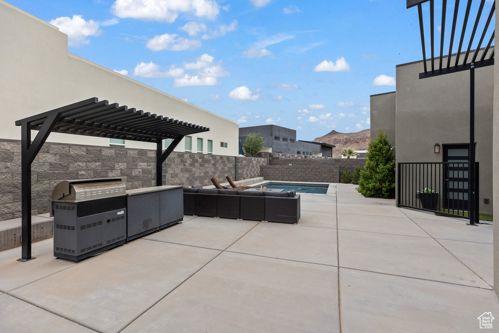 View of patio with an outdoor living space, a pergola, area for grilling, and fence