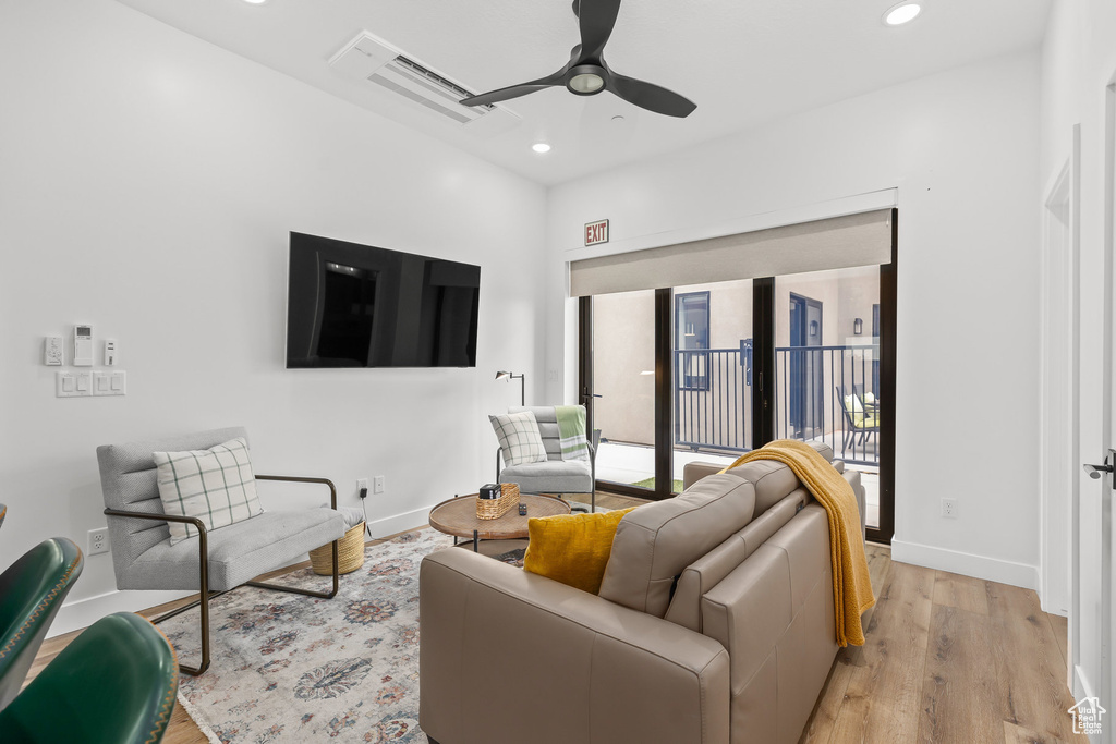 Living room with ceiling fan, recessed lighting, light wood-style flooring, and baseboards