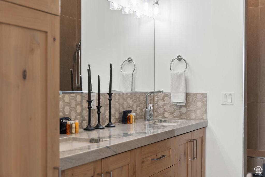 Bathroom featuring decorative backsplash and vanity