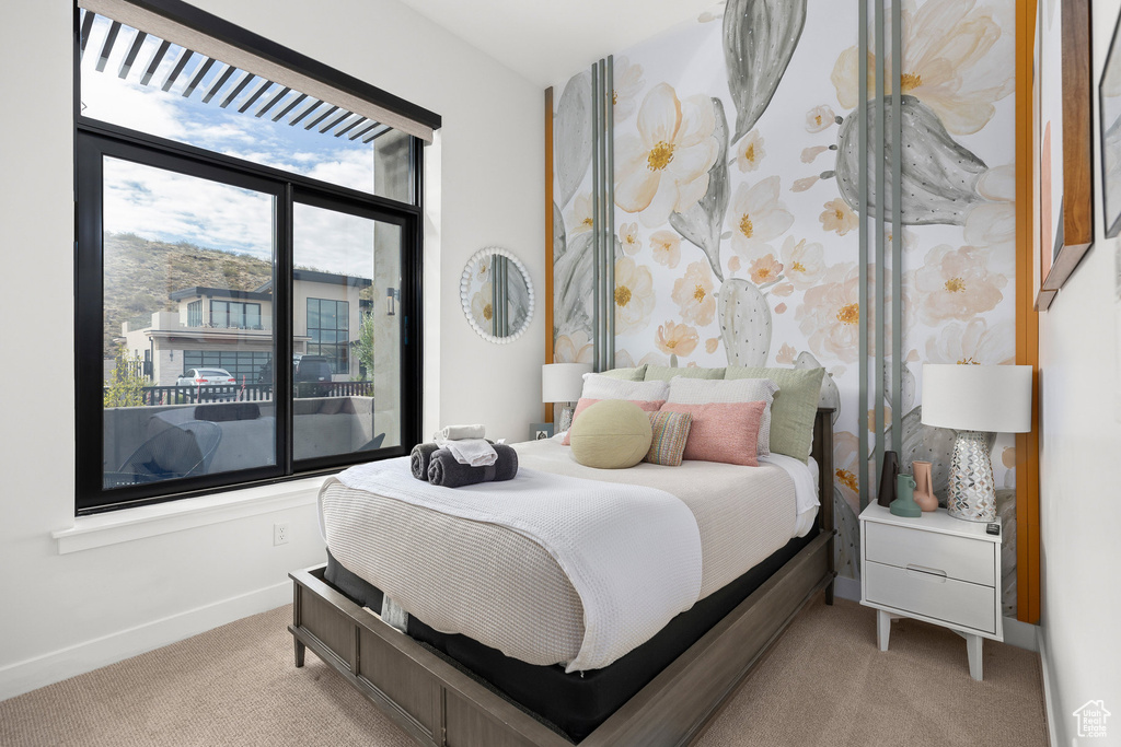 Bedroom with light carpet and baseboards