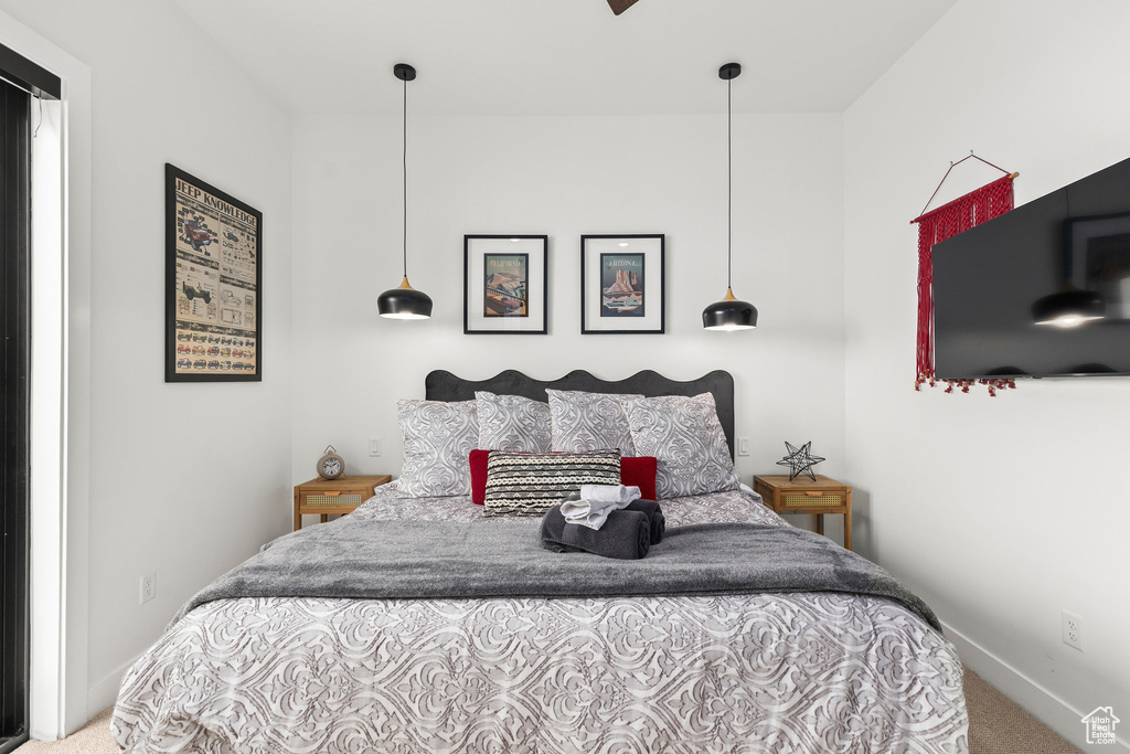 Bedroom featuring carpet floors and baseboards
