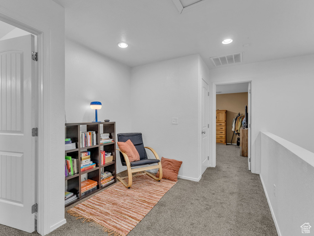 Living area with baseboards, recessed lighting, carpet flooring, and visible vents