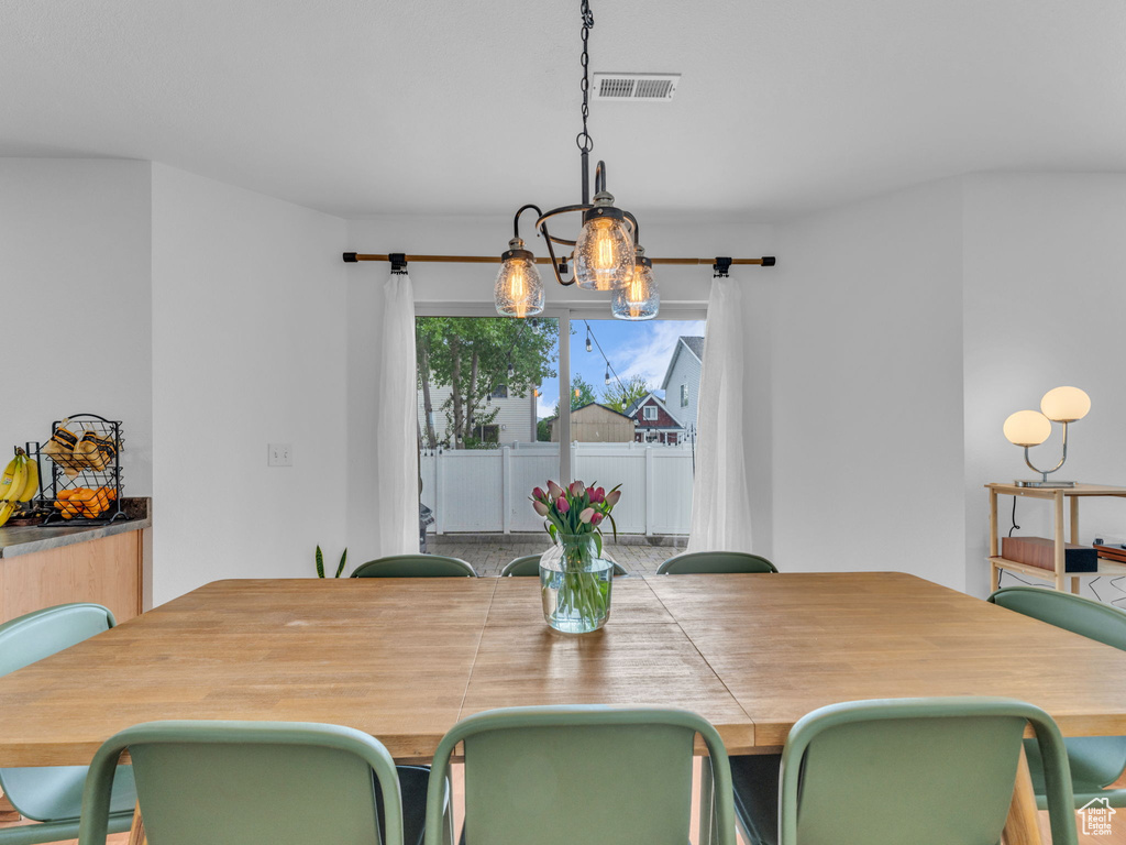 Dining area with visible vents and a notable chandelier