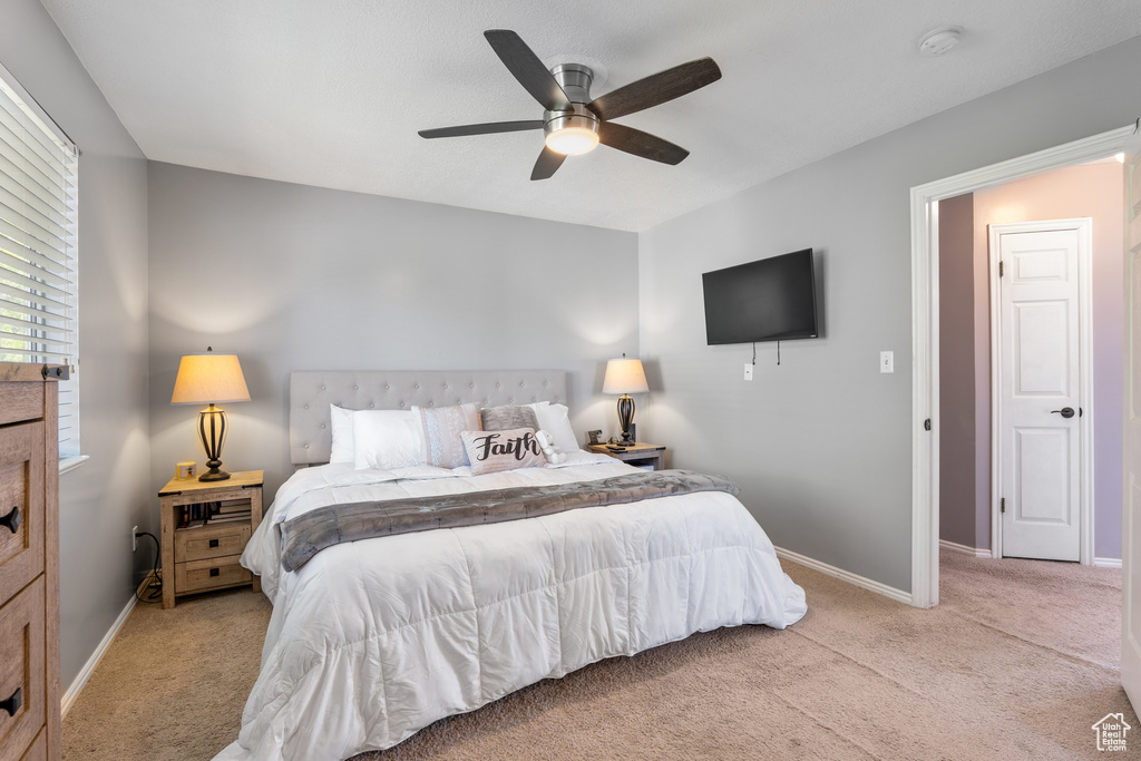 Bedroom with carpet flooring, baseboards, and ceiling fan