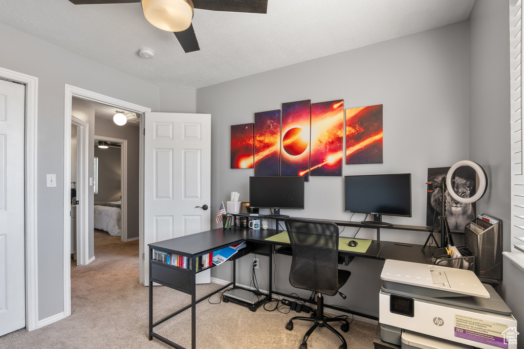 Carpeted office with ceiling fan