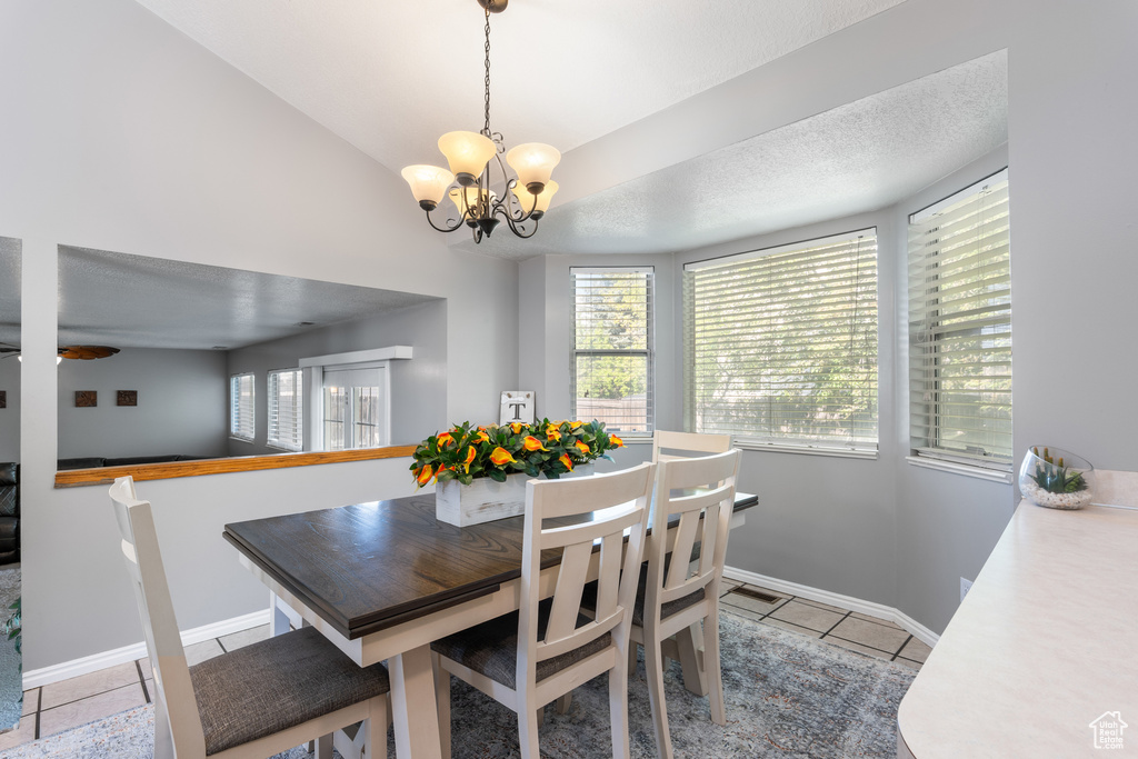 Dining area featuring a chandelier, plenty of natural light, and baseboards
