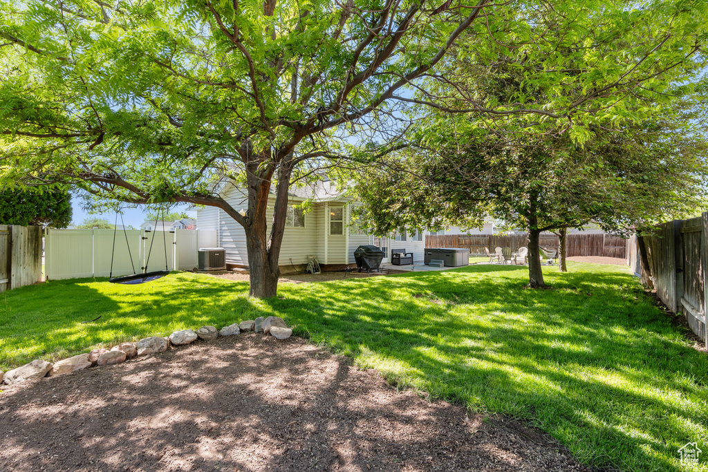 View of yard featuring central air condition unit and a patio