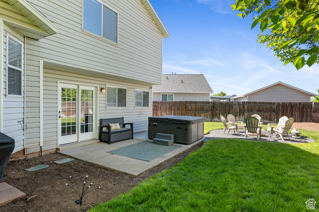 View of yard with a hot tub and a patio area