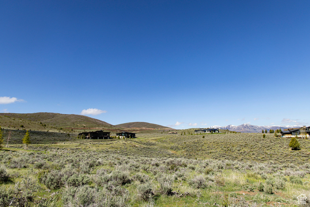 View of mountain backdrop with rural landscape