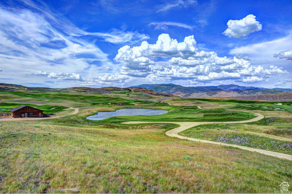 Surrounding community with a water and mountain view and view of golf course