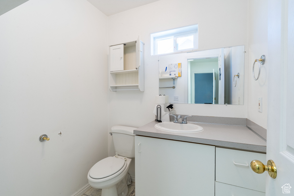 Half bathroom with toilet and vanity