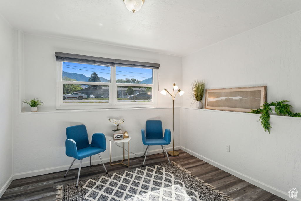 Living area with wood finished floors and baseboards