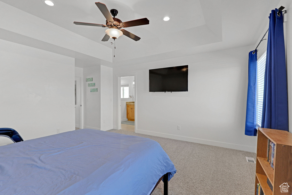 Bedroom with light colored carpet, multiple windows, recessed lighting, baseboards, and ceiling fan