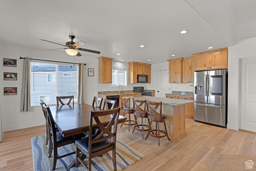 Dining room with light wood-type flooring, ceiling fan, recessed lighting, and baseboards