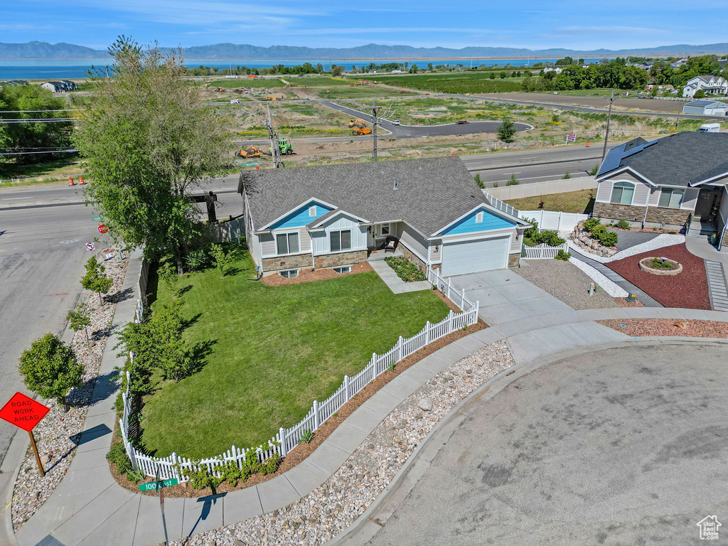 Aerial view of property and surrounding area with a mountainous background