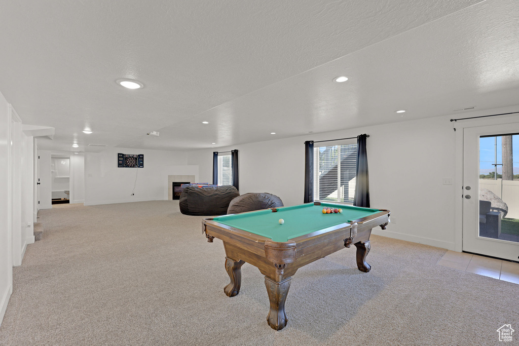 Game room with recessed lighting, healthy amount of natural light, billiards table, light colored carpet, and a textured ceiling