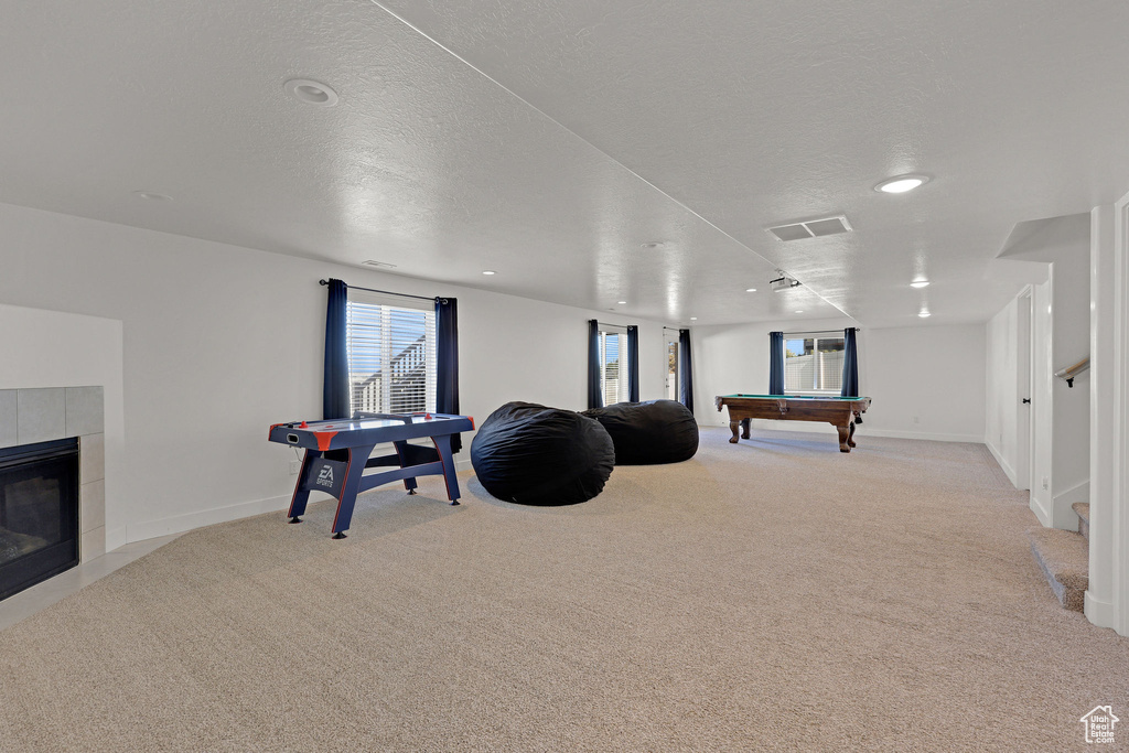 Game room with billiards, light carpet, recessed lighting, a tiled fireplace, and baseboards