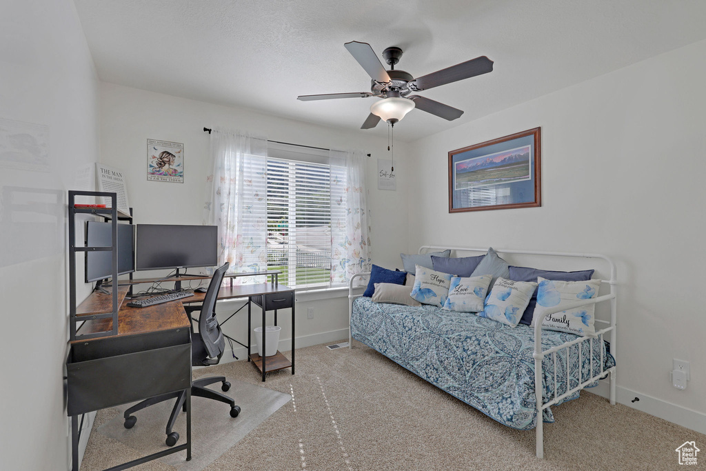 Bedroom with baseboards, carpet, an office area, and a ceiling fan
