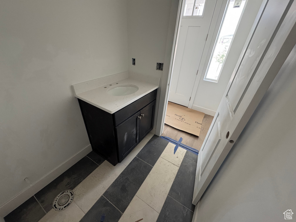 Bathroom with plenty of natural light, vanity, and tile patterned flooring