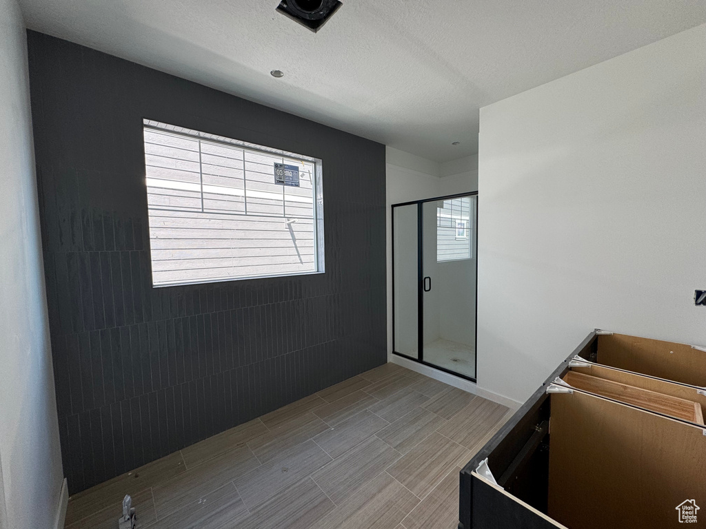 Full bathroom featuring a stall shower and wood tiled floors