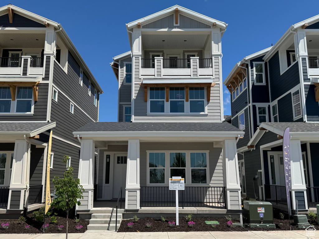 View of front of house featuring a balcony, a porch, and board and batten siding