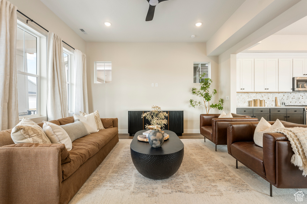 Living area featuring a ceiling fan, recessed lighting, and baseboards
