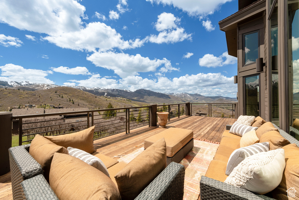 Deck featuring a mountain view and outdoor lounge area