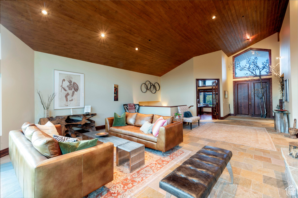 Living room with wood ceiling, baseboards, recessed lighting, and high vaulted ceiling