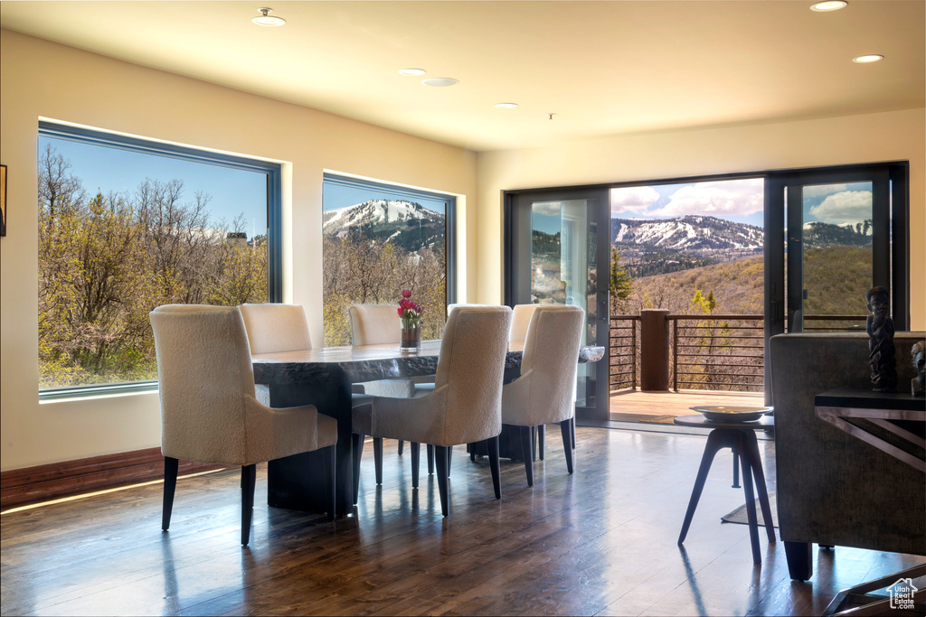 Dining area with recessed lighting, a mountain view, and wood finished floors