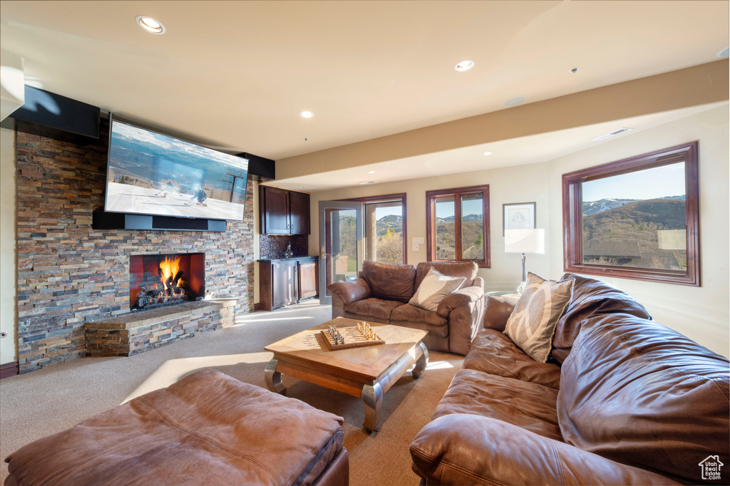 Carpeted living room with a fireplace and recessed lighting