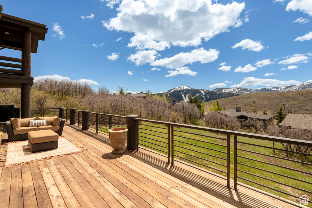 Deck featuring an outdoor living space and a mountain view
