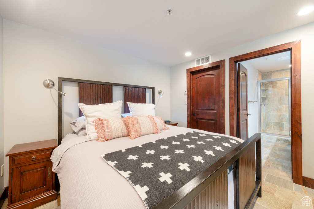 Bedroom with light stone finish flooring and recessed lighting