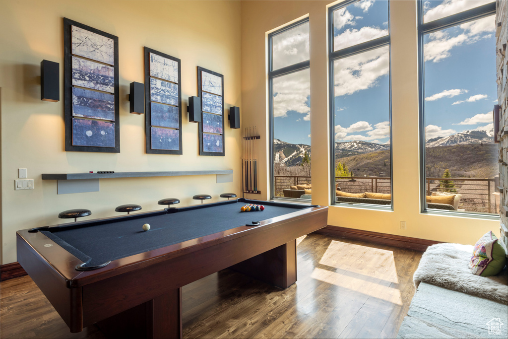 Rec room featuring billiards table, wood finished floors, baseboards, and a mountain view