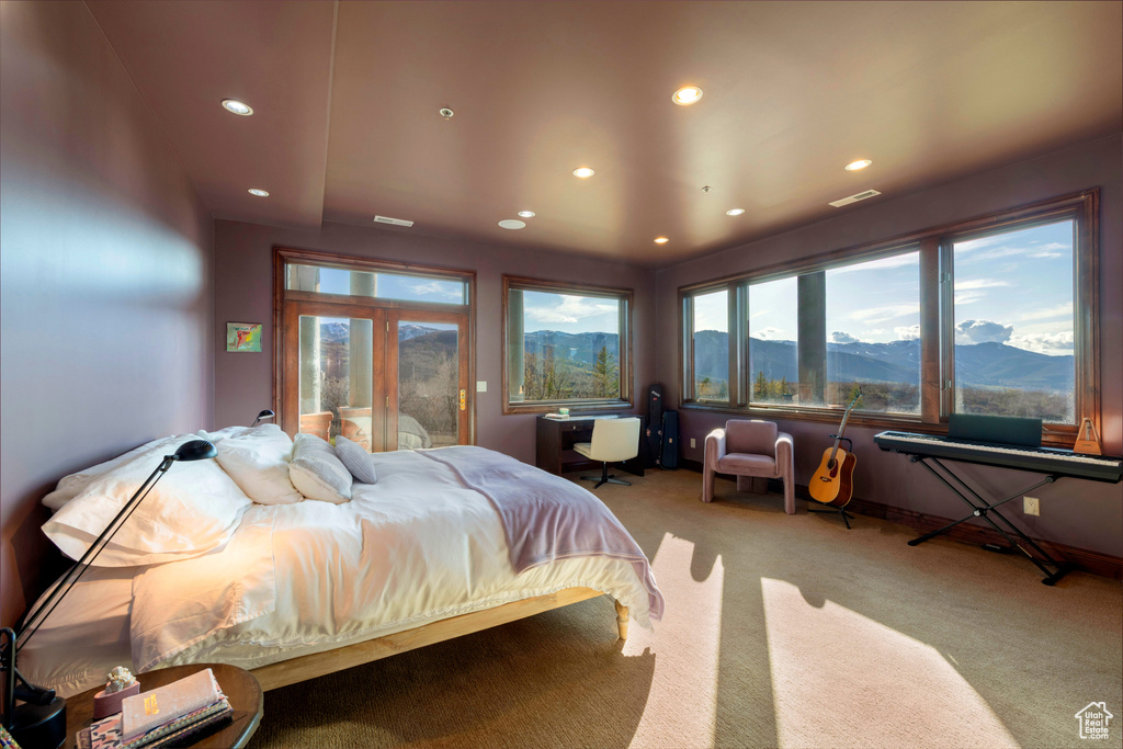 Carpeted bedroom with recessed lighting and a mountain view