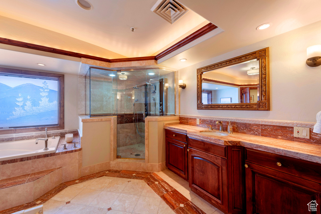 Bathroom featuring tile patterned flooring, a shower stall, vanity, a garden tub, and recessed lighting