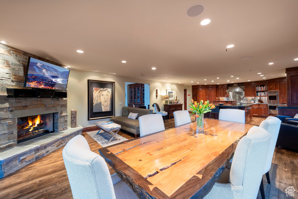 Dining space featuring recessed lighting, a fireplace, and wood finished floors