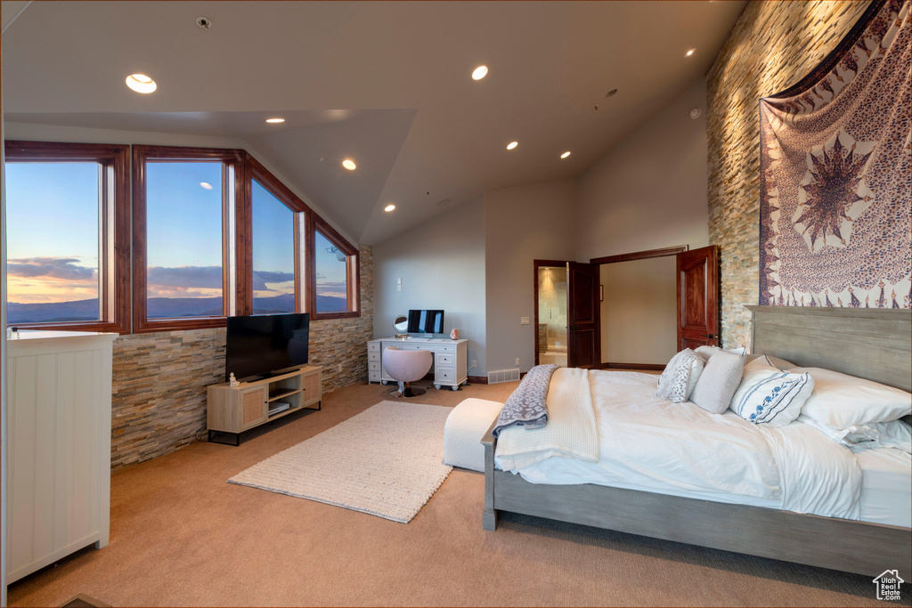 Carpeted bedroom with lofted ceiling and recessed lighting