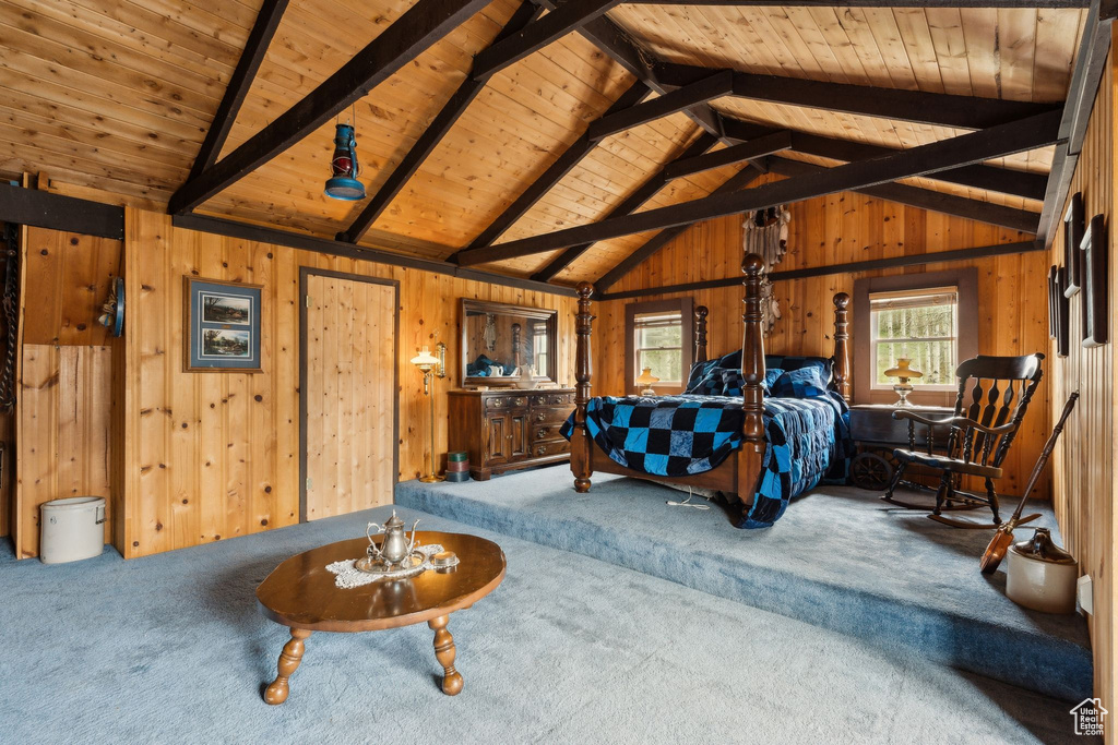 Carpeted bedroom with wooden ceiling and wooden walls