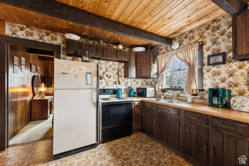Kitchen featuring freestanding refrigerator, electric stove, wallpapered walls, wooden ceiling, and black microwave