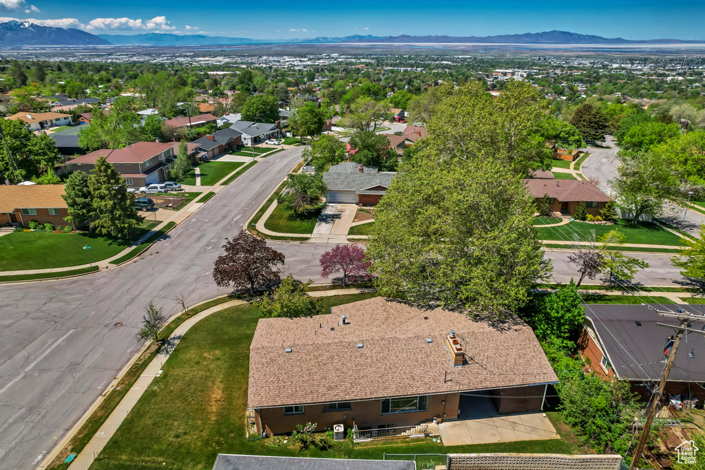 Aerial overview of property\'s location with a mountain backdrop and nearby suburban area
