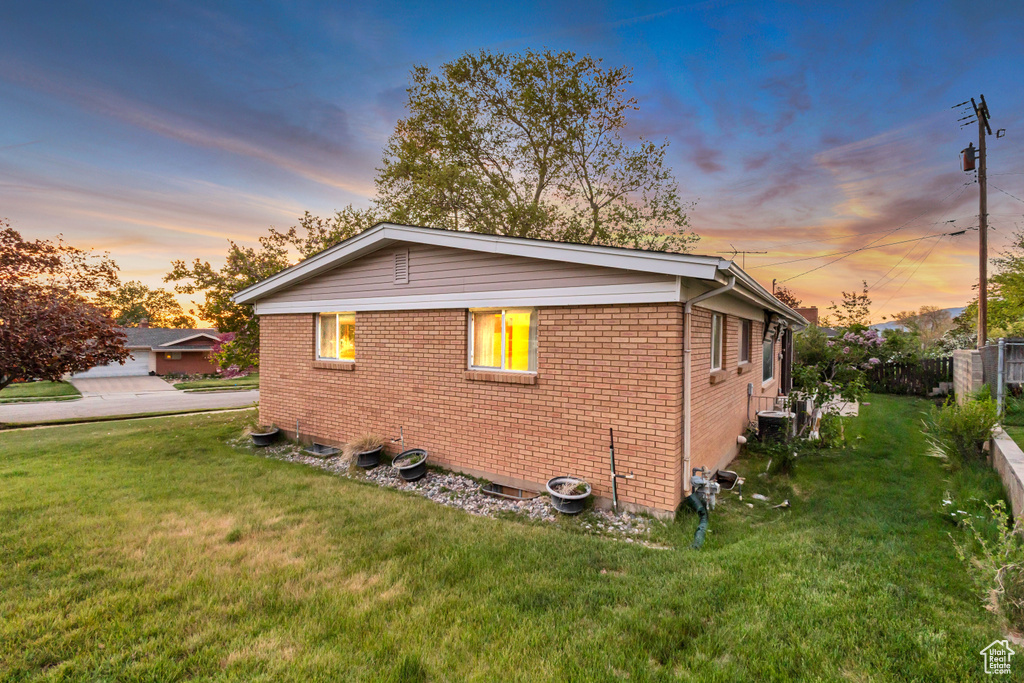 Property exterior at dusk featuring brick siding and central air condition unit