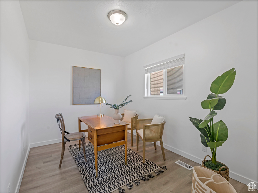 Office with light wood-style floors and baseboards