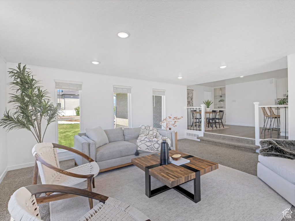 Living room featuring light carpet, recessed lighting, and baseboards