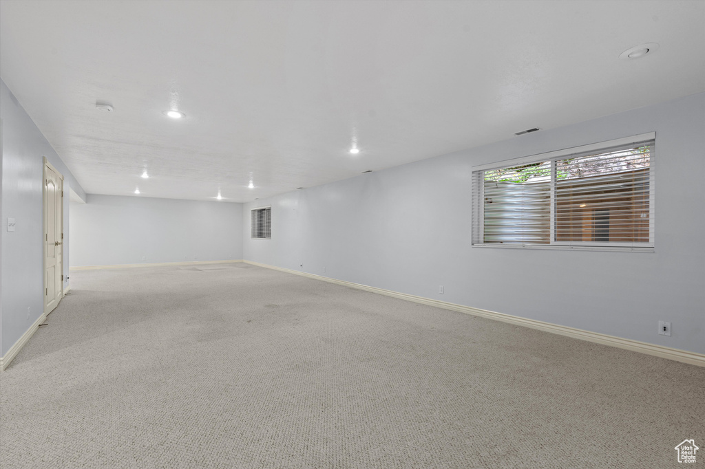 Below grade area featuring baseboards, carpet flooring, and recessed lighting
