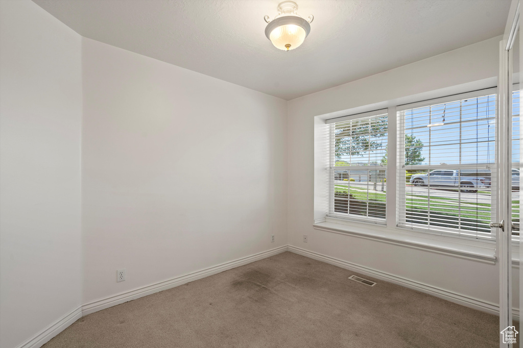 Spare room with carpet floors and baseboards